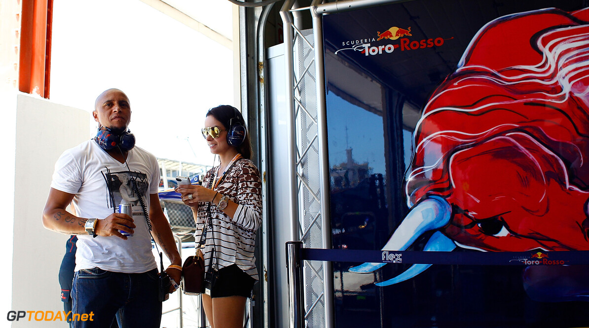 141017626VR022_European_F1_
VALENCIA, SPAIN - JUNE 23:  Former football star Roberto Carlos with guest are seen in Toro Rosso garage during qualifying for the European Grand Prix at the Valencia Street Circuit on June 23, 2012 in Valencia, Spain.  (Photo by Vladimir Rys/Getty Images) *** Local Caption *** Roberto Carlos
European F1 Grand Prix - Qualifying
Vladimir Rys
Valencia
Spain

Formula One Racing F1