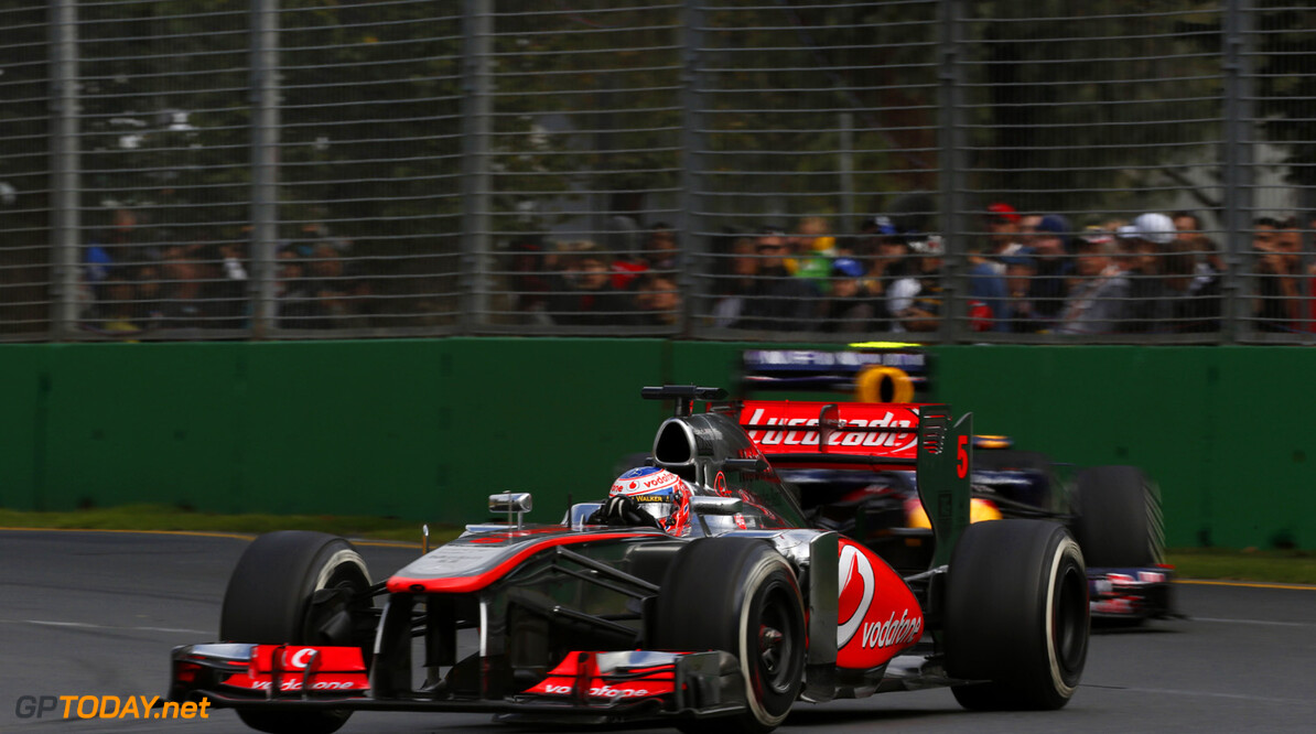 Jenson Button leads Mark Webber of Red Bull Racing