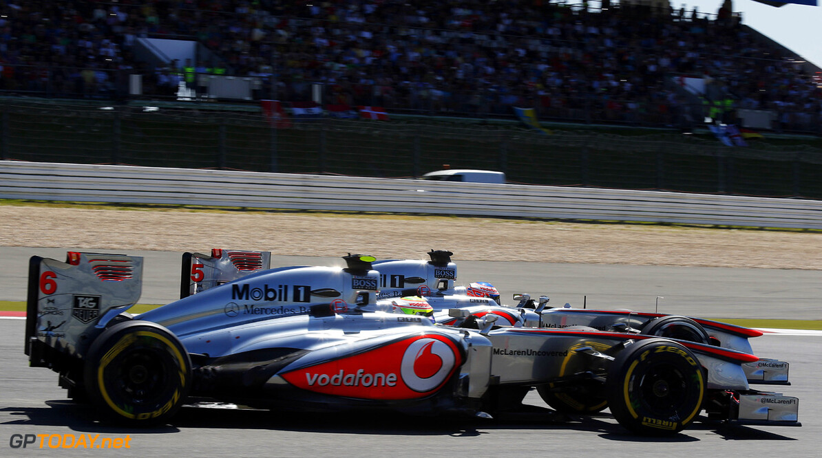 Jenson Button and Sergio Perez on track