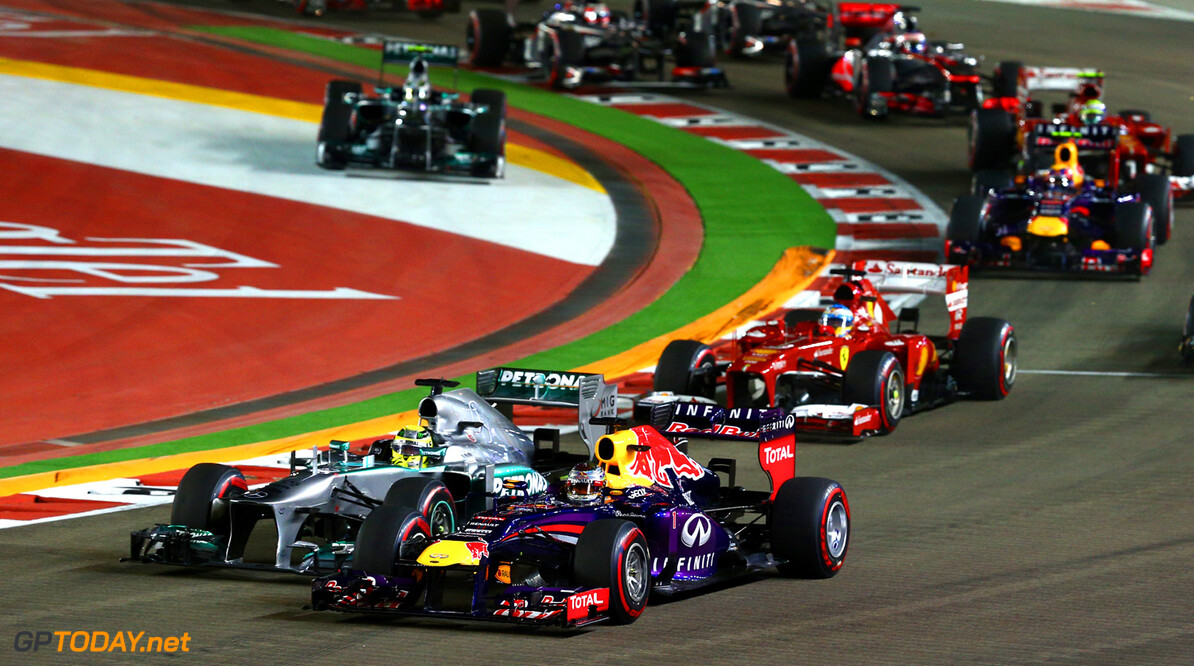 SINGAPORE - SEPTEMBER 22:  Sebastian Vettel of Germany and Infiniti Red Bull leads Nico Rosberg of Germany and Mercedes GP and Fernando Alonso of Spain and Ferrar into turn three during the Singapore Formula One Grand Prix at Marina Bay Street Circuit on September 22, 2013 in Singapore, Singapore.  (Photo by Paul Gilham/Getty Images) *** Local Caption *** Sebastian Vettel;Nico Rosberg;Fernando Alonso
F1 Grand Prix of Singapore
Paul Gilham
Singapore
Singapore