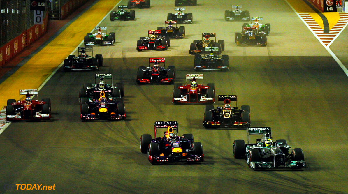 SINGAPORE - SEPTEMBER 22:  Nico Rosberg of Germany and Mercedes GP leads Sebastian Vettel of Germany and Infiniti Red Bull into the first turn during the Singapore Formula One Grand Prix at Marina Bay Street Circuit on September 22, 2013 in Singapore, Singapore.  (Photo by Justin Davies/Getty Images) *** Local Caption *** Sebastian Vettel;Nico Rosberg
F1 Grand Prix of Singapore
Justin Davies
Singapore
Singapore