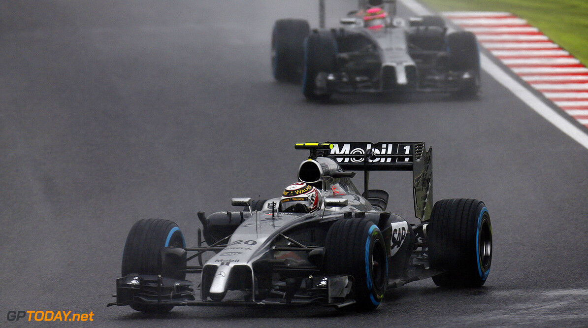 Kevin Magnussen leads Jenson Button on track.
