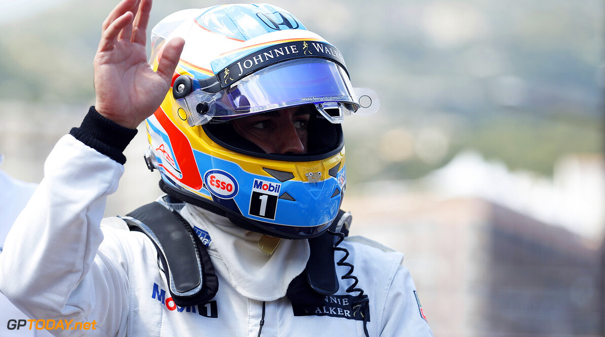 Fernando Alonso waves to the fans.