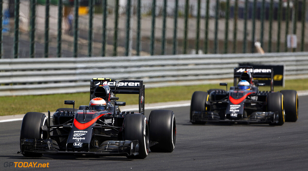 Jenson Button and Fernando Alonso on track.