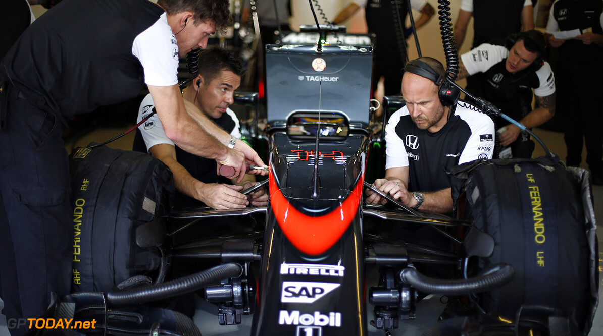 The team at work on Fernando Alonso's car in the garage.