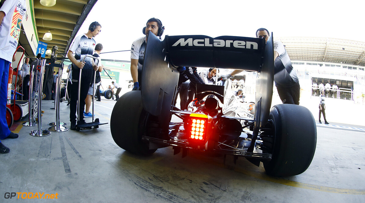 Jenson Button is wheeled into the pit garage.

Steven Tee