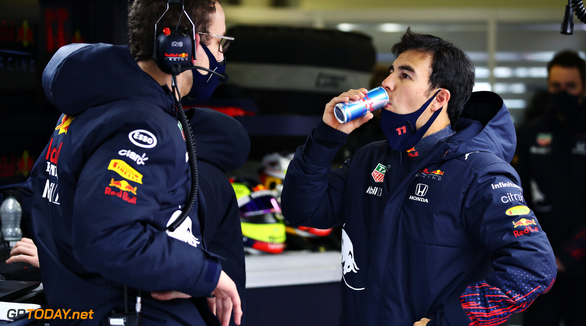 NORTHAMPTON, ENGLAND - FEBRUARY 22: Sergio Perez of Mexico and Red Bull Racing talks with an engineer in the garage during the Red Bull Racing filming day at Silverstone on February 22, 2021 in Northampton, England. (Photo by Mark Thompson/Getty Images for Red Bull Racing) // Getty Images / Red Bull Content Pool  // SI202102230144 // Usage for editorial use only // 
Red Bull Racing Filming Day




SI202102230144